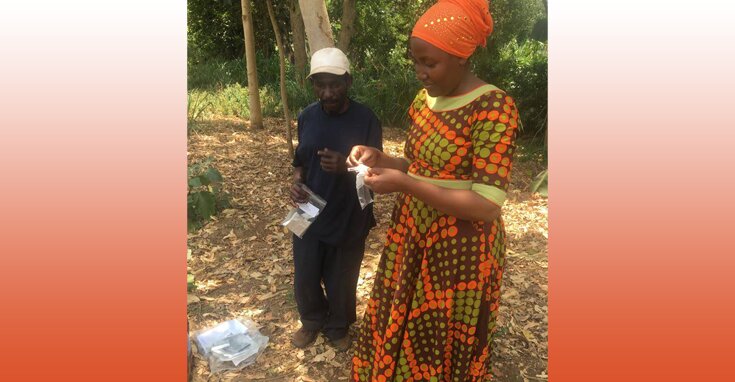 Community monitor performing a water test