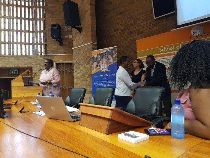 prof. douglas handing a certificate of attendance to a community health worker during the award ceremony at the university of limpopo in march 2019